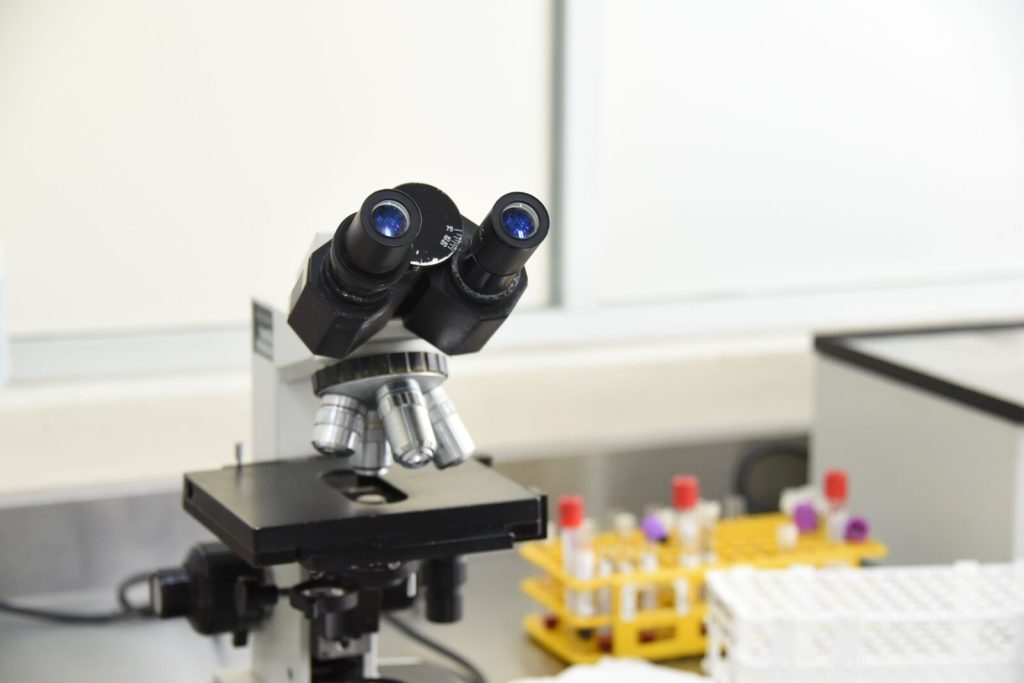 Laboratory microscope beside test tubes in a scientific research facility