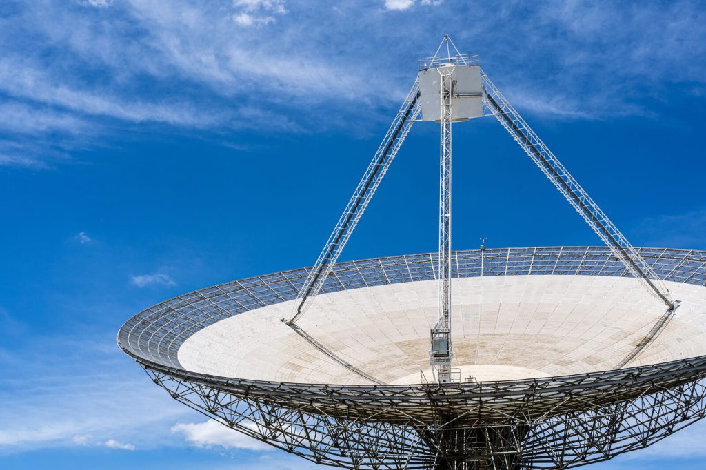 Large satellite dish pointed toward a clear blue sky