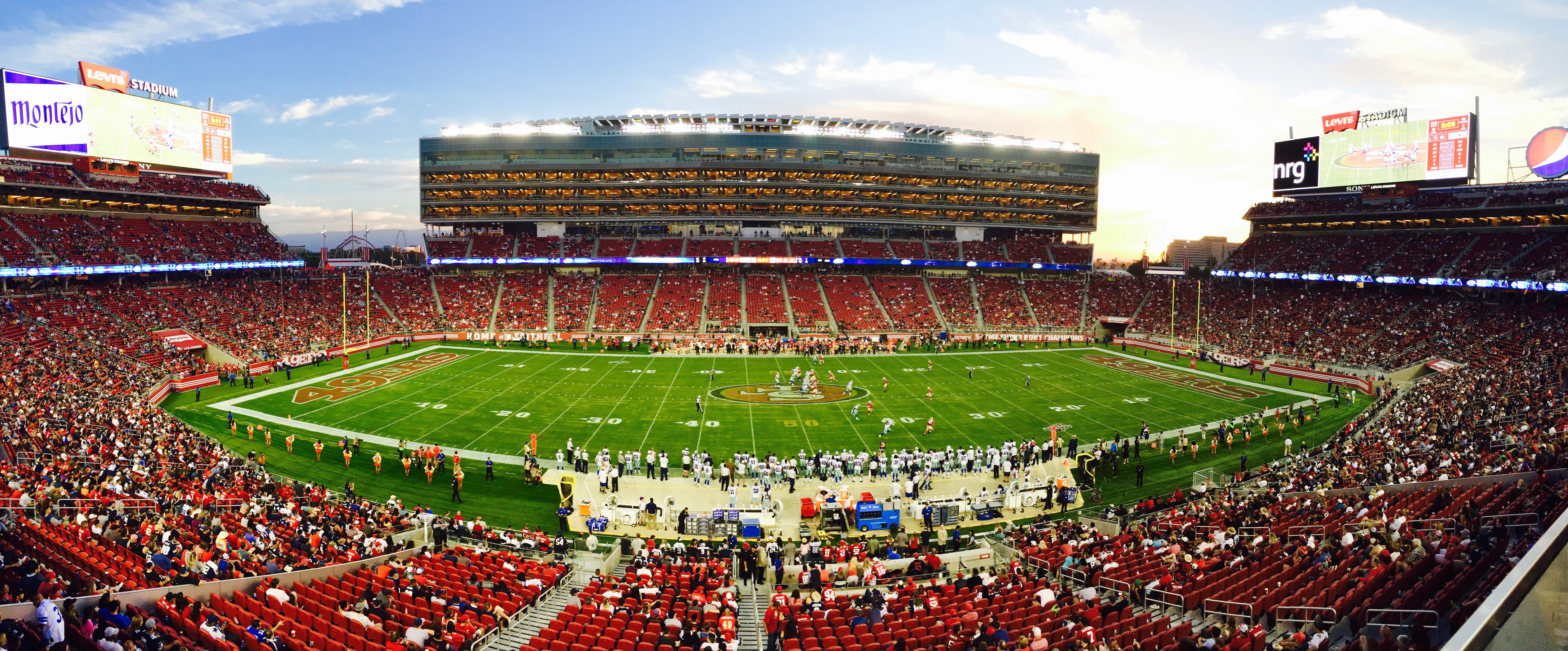 Packed American football stadium at sunset