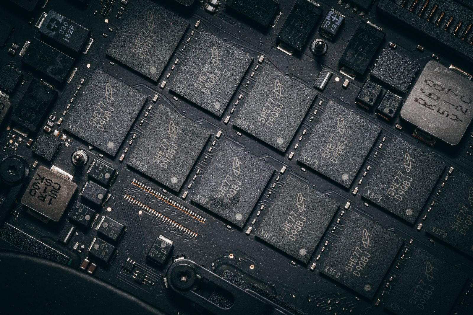 Close-up of black memory chips and electronic components on a computer circuit board.