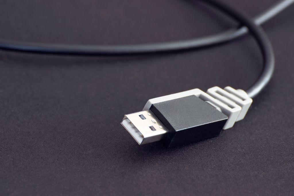 Close-up of a black USB-C cable connector against a dark background.