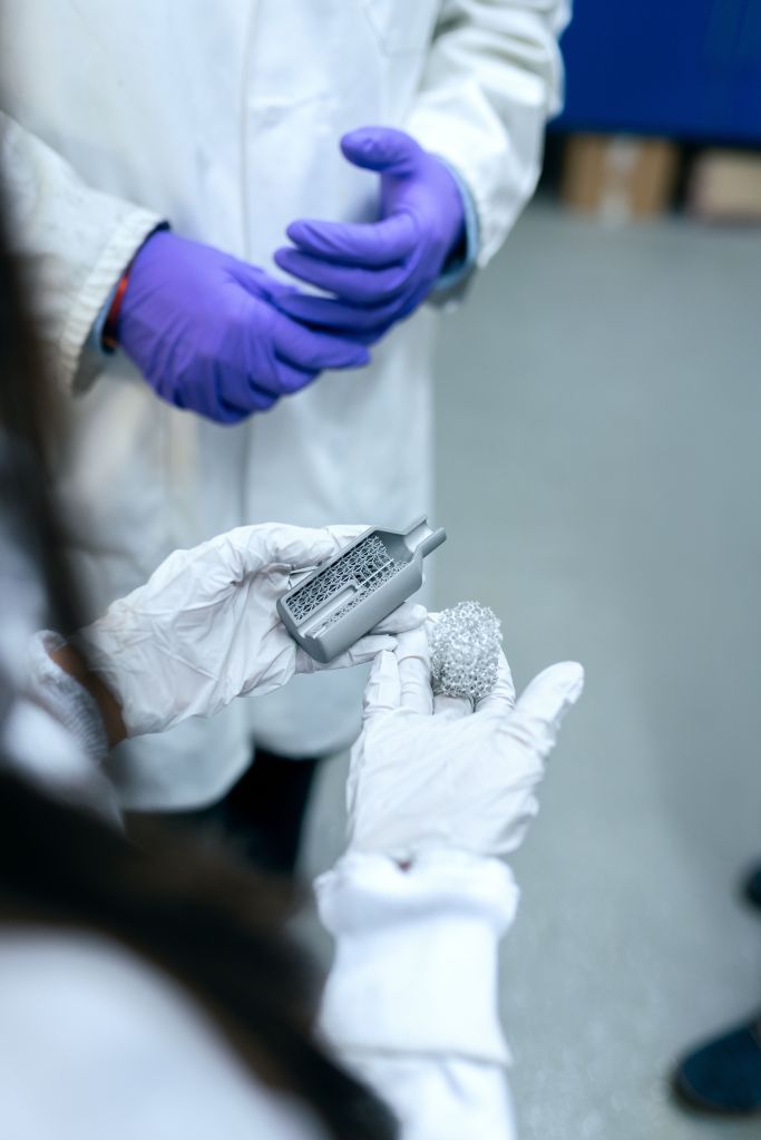 Engineer in a laboratory holding a stack of battery material samples